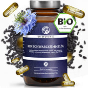 Bio Schwarzkümmelöl im braunen Glas mit silbernem Deckel, umgeben von veganen Softgel-Kapseln, Schwarzkümmelsamen und Nigella-Blume. Hergestellt aus kaltgepresstem, biozertifiziertem Öl. Premiumqualität, laborgeprüft.